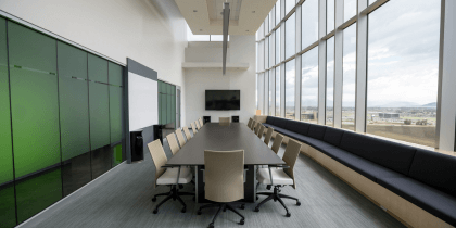 Rectangular brown wooden table with chair lot inside building