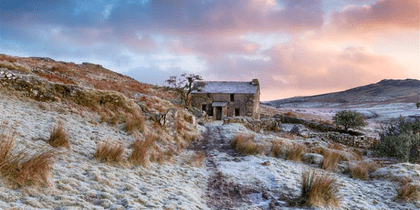 Farmhouse under a sunset