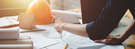 Hands of architect or engineer using compass working with blueprint on desk in office. Engineering tools and construction concept. Architect and Business concept.Teamwork Concept.Vintage effect.