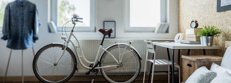 Bike resting against a radiator.